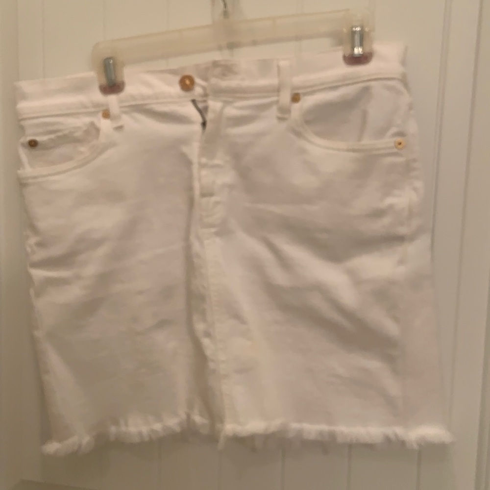 Ladies white denim skirt with fringed trim.